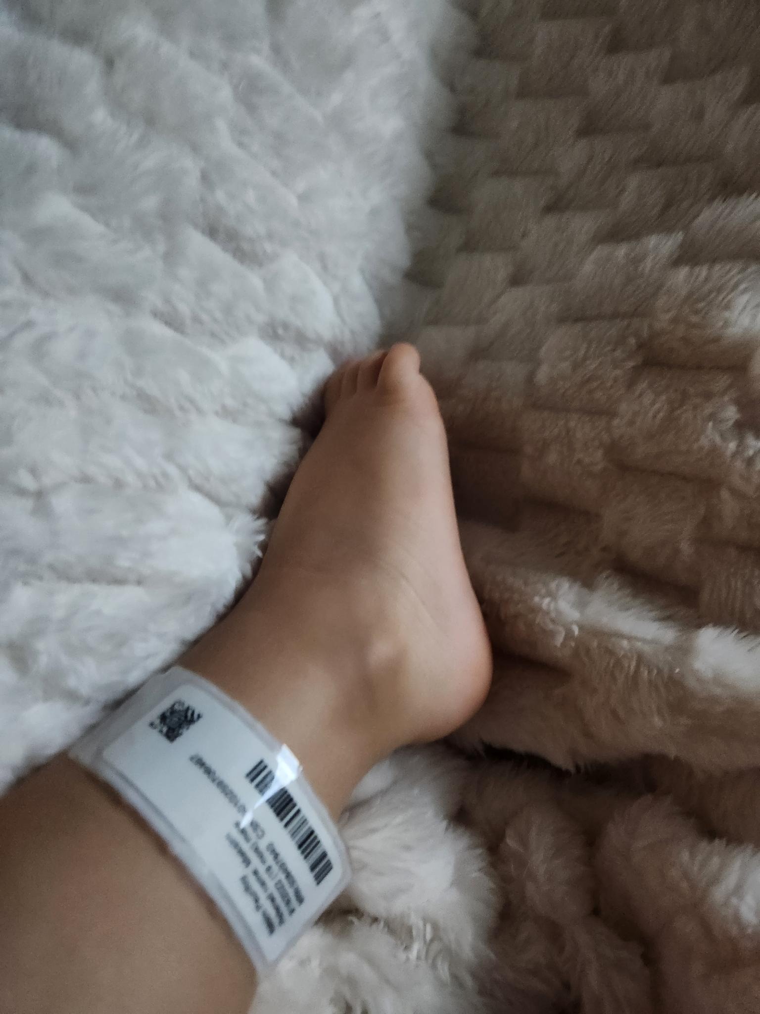 A child's foot with a hospital ankle bracelet